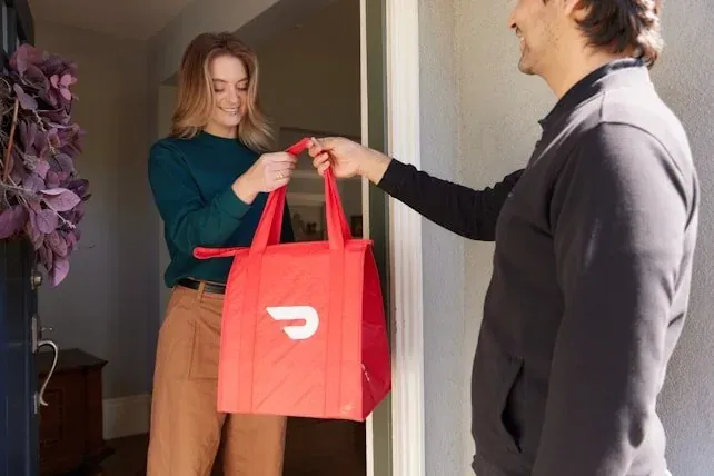 Hans Air Express courier agent completing doorstep parcel handover to customer